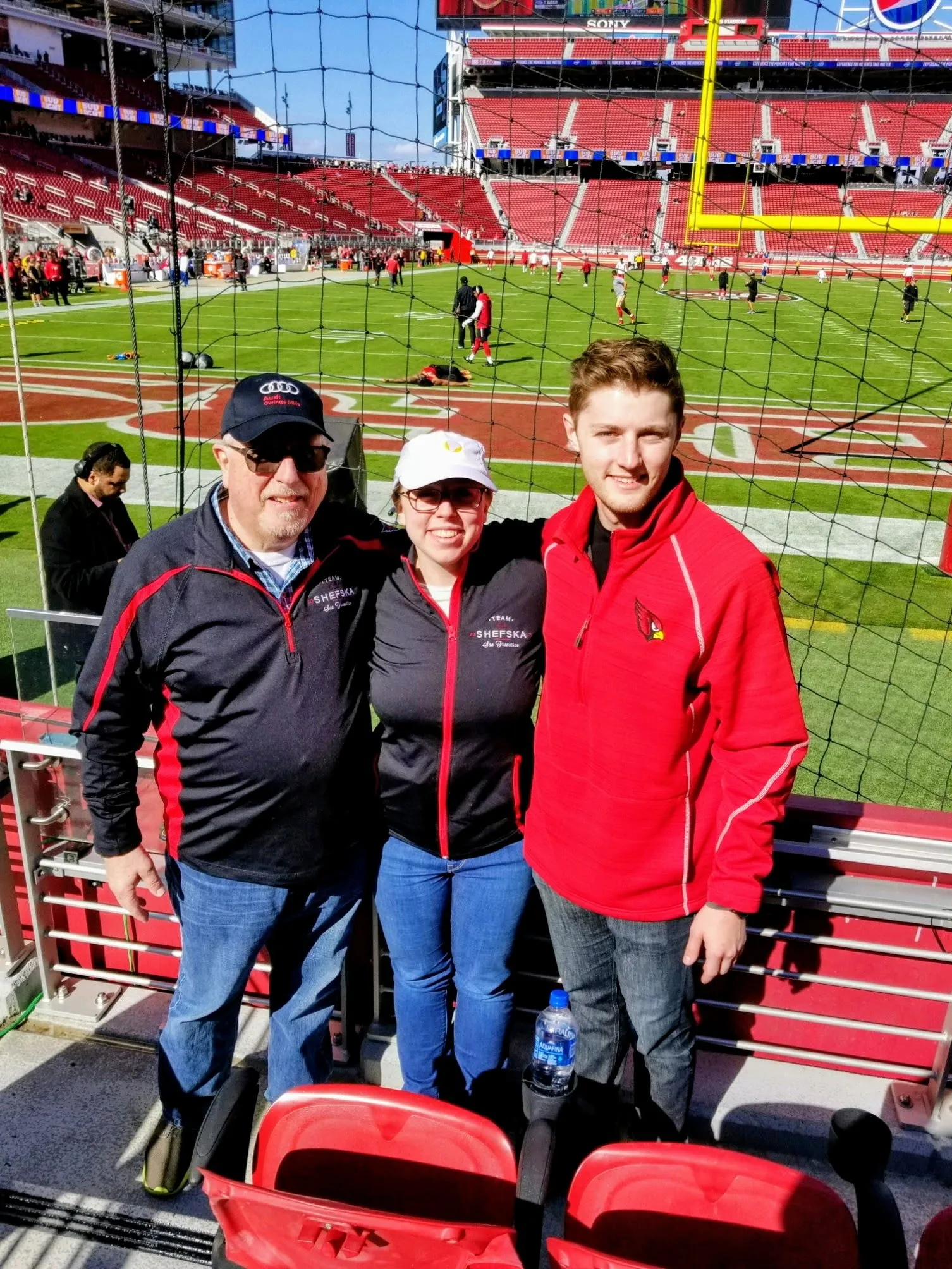 Suzanne, Ray and Zach at a football stadium